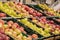 apples in a supermarket on showcases in boxes, fruits in a store