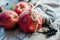 Apples tied with a rope with cinnamon on a piece of gray linen