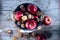 Apples and walnuts in shells filled in basket, top shot, autumn sunlight