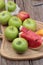 Apples and watermelon delicious on wood background.