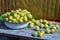 Apples in a white metal pelvis on a wooden bench