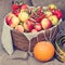 Apples in wicker basket, pumpkin, marrow and rowan berry