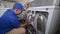 Appliance Technician Cleaning an Electric Dryer