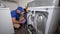 Appliance Technician Cleaning Out a Dryer Chute