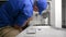 Appliance Technician Installing a Spray Arm on Dishwasher
