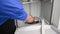 Appliance technician removing a dishwasher strainer basket