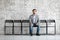 Applicant sit on chair prepared for job interview waiting his turn