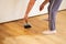Application of oil-based floor finish on luxury oak parquet flooring