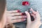 Application of a red varnish on the nail. Manicure in the beauty