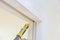 Applying silicone on of molding door trim with caulking gun tool