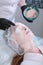 Applying a thick alginate mask to a woman& x27;s face in a beauty salon. The concept of keeping the skin young and toned