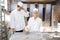 Apprentice in bakery trying to form a pretzel out of dough