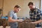 Apprentice in carpentry helps build furniture