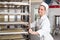 Apprentice or worker in bakery push Rack with dough