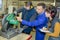 Apprentices working on machine - metal processing