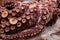 Approach to an arm of a marine octopus with its huge tentacles. Food of marine origin