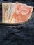 approach to front pocket of jeans in blue with honduran banknotes