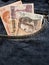 approach to front pocket of jeans in blue with Honduran banknotes