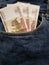 approach to front pocket of jeans in blue with Russian banknotes