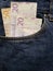approach to front pocket of jeans in blue with swedish banknotes