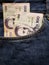 approach to front pocket of jeans in blue with uruguayan banknotes