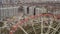 Approaching aerial shot of the famous Ferris wheel in Kharkov in Gorky Park and construction site with cranes behind