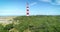 Approaching Ameland Lighthouse Flying Over Trees - Ameland, The Netherlands, 4K Drone Footage