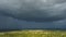 Approaching dark stormy clouds forming on gloomy sky during heavy rainfall over suburban town area. Trunderstorm season