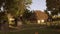 Approaching old rustic house with straw roof.