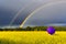 Approaching thunderstorm to rapeseed field with lonely umbrella