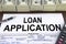Approved loan application form and dollar bills