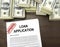 Approved loan application form and dollar bills