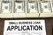 Approved small business loan application form and money