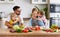 Appy family with child preparing vegetable salad