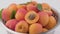 Apricot fruit with apricot slices in colander rotates