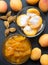 Apricot halves with sugar and jam in glass bowls. Steps for making apricot jam. Top view