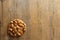 Apricot kernels handful put as circle on wooden background. Food concept with copy space. Product is good for cardio