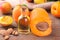 Apricot seed oil next to apricots on a brown background