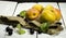 Apricots and black currant on a white wooden background