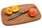 Apricots and a knife on a wooden cutting board