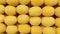 Apricots laid out in a geometric order on the counter in the supermarket. Background from top view of yellow apricots with copy