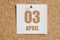 April 03. 03th day of the month, calendar date.  White calendar sheet attached to brown cork board.Spring month, day of the year