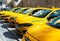 April 10, 2021, Istanbul, Turkey: Yellow city taxi cars stand in a row in the parking lot.