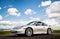 April 2, 2018 Eugene Oregon - A silver Porsche 911 sits in an empty rural road.