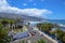 April 2018, Puerto de la Cruz, Canary Islands, Spain. City, beach with big waves, palm trees and a road with cars.