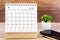 April 2022 desk calendar on wooden table