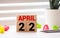 April 22 text on wooden blocks, calendar april number white cube