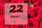 April 22th. Day of 22 month, calendar date. Natural background of red roses. A bouquet of dark red roses