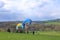 April 25 2021 - Dresden/Germany: Paragliders taking off in front of a green hill