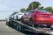 April 26, 2019 Redwood City / CA / USA - Car transporter carries Tesla Model 3 new vehicles along a highway in San Francisco bay